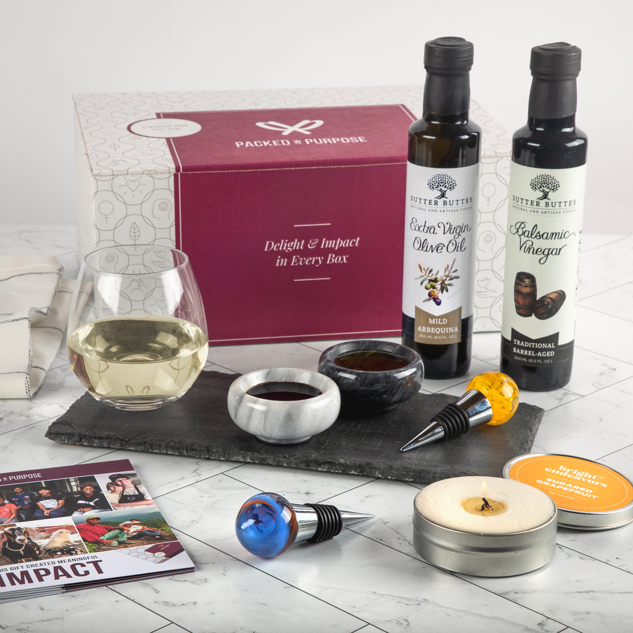 For the Entertainer Gift Basket with Sutter Buttes extra virgin olive oil, balsamic vinegar, glass wine stoppers, tealight candle, and a glass of white wine. Ideal for VIP Clients.