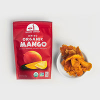 Thumbnail for Package of Mavuno Harvest dried organic mango next to a small white bowl filled with dried mango slices