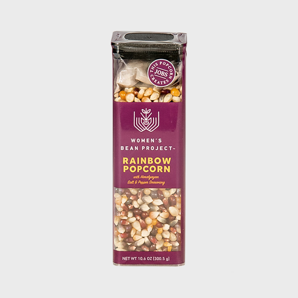 Women's Bean Project Rainbow Popcorn in container with colorful kernels and seasoning packet