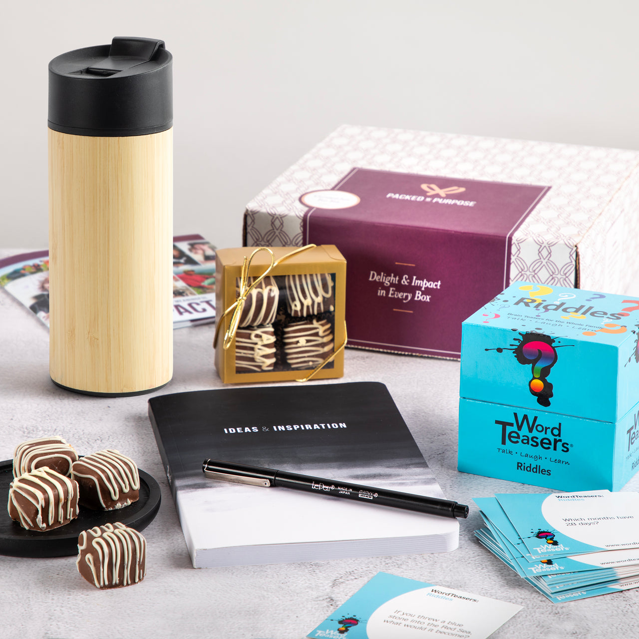 Office Desk Essentials gift box—featuring a bamboo mug, treats, inspirational notebook with pen, ideal for employee appreciation