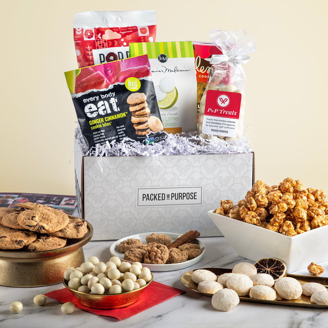 Open gift basket labeled ‘A Sweet Thanks’ with cookies, southern-style toffee, chocolate covered almonds, and gourmet popcorn.