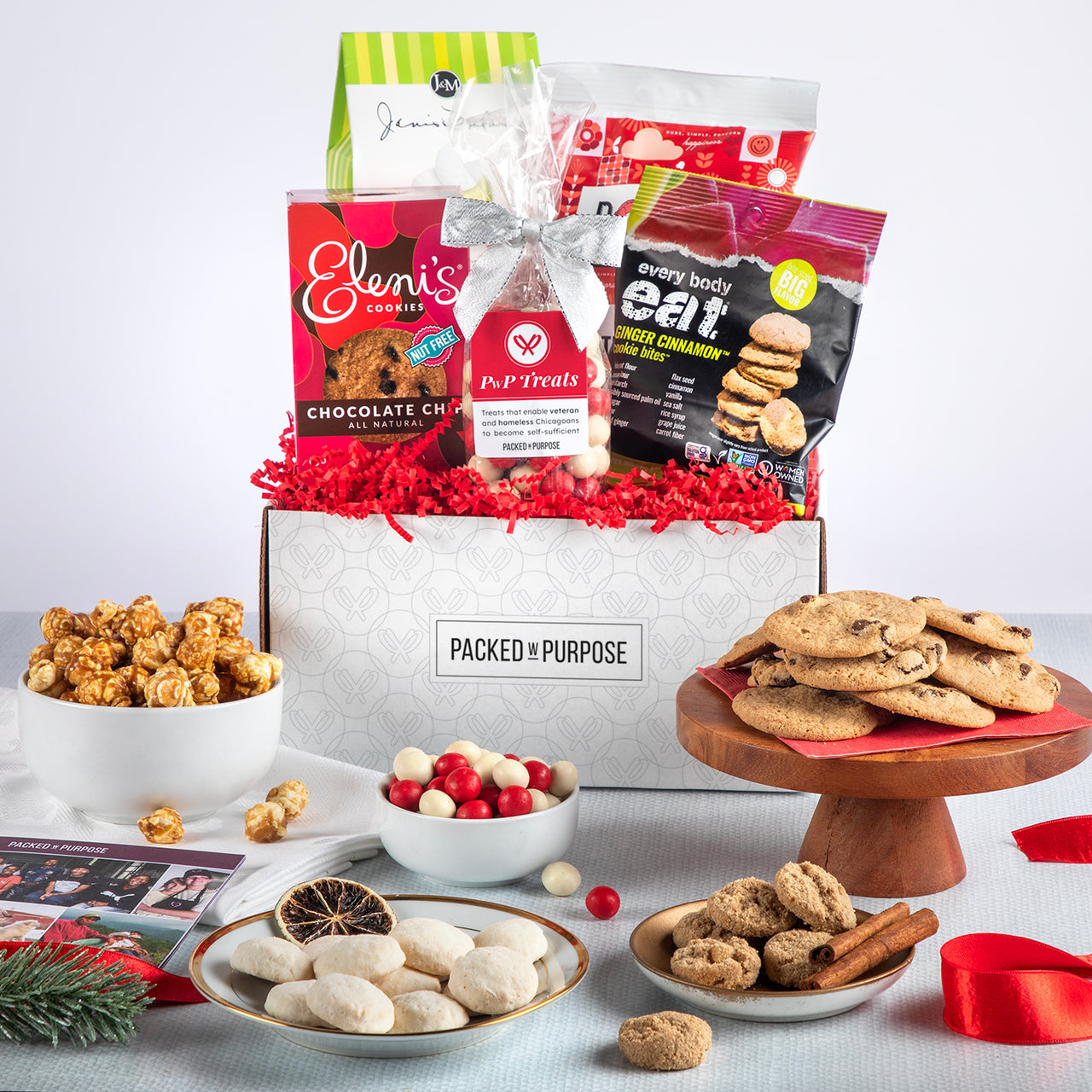 Open holiday edition gift basket labeled ‘A Sweet Thanks’ with cookies, southern-style toffee, chocolate covered almonds, and gourmet popcorn