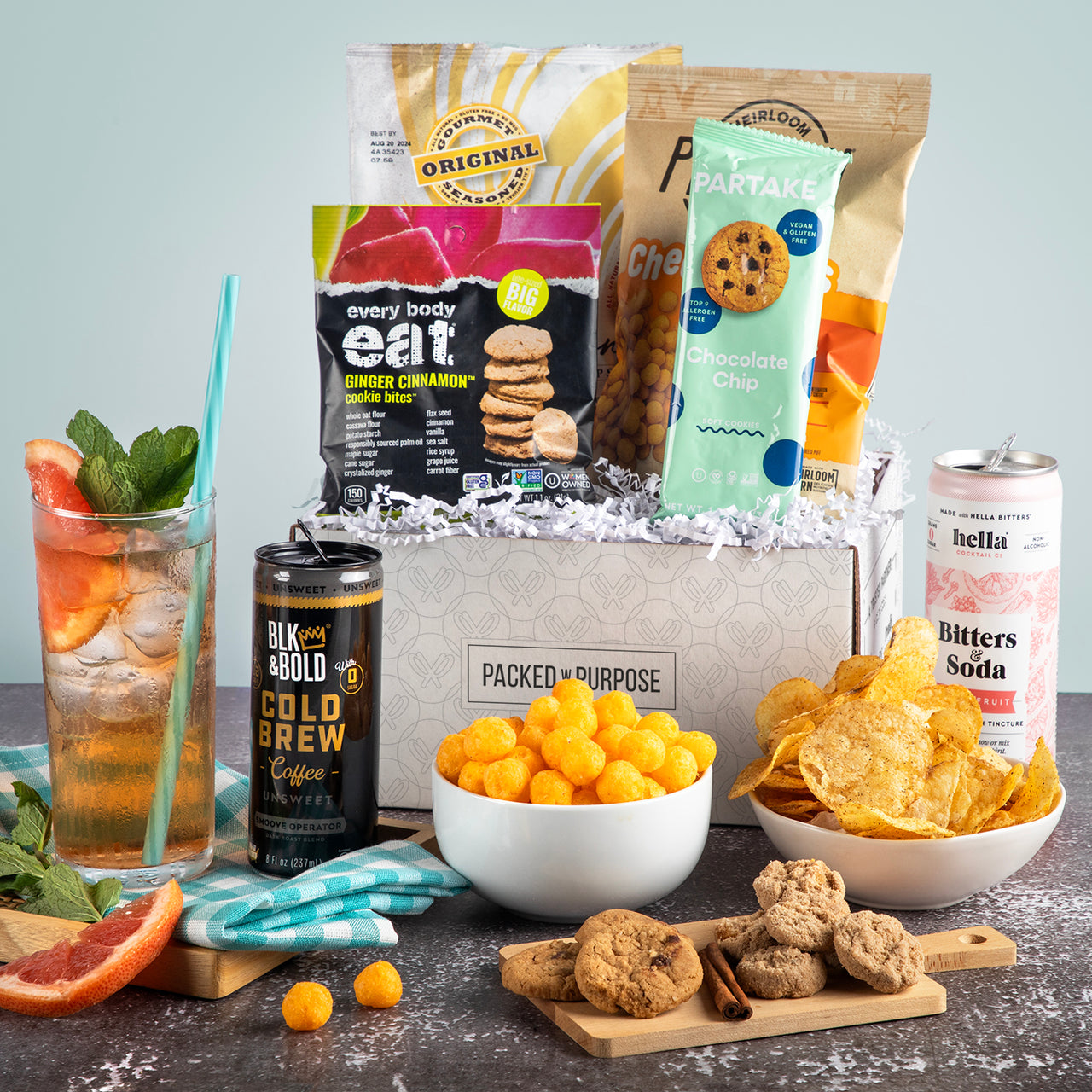 Open gift basket labeled ‘Black-Owned Spotlight’ with cookies, popcorn, chips, and cold brew coffee.