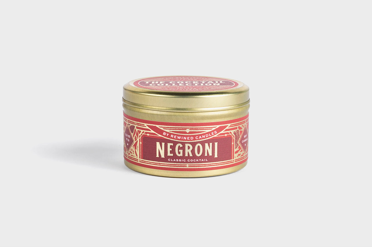 Negroni cocktail-scented soy wax candle in gold foil tin