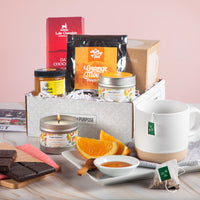 Thumbnail for Care package labeled ‘Relax & Unwind’ with dark chocolate, spa candle, honey, peach tea, and terrazzo mug.